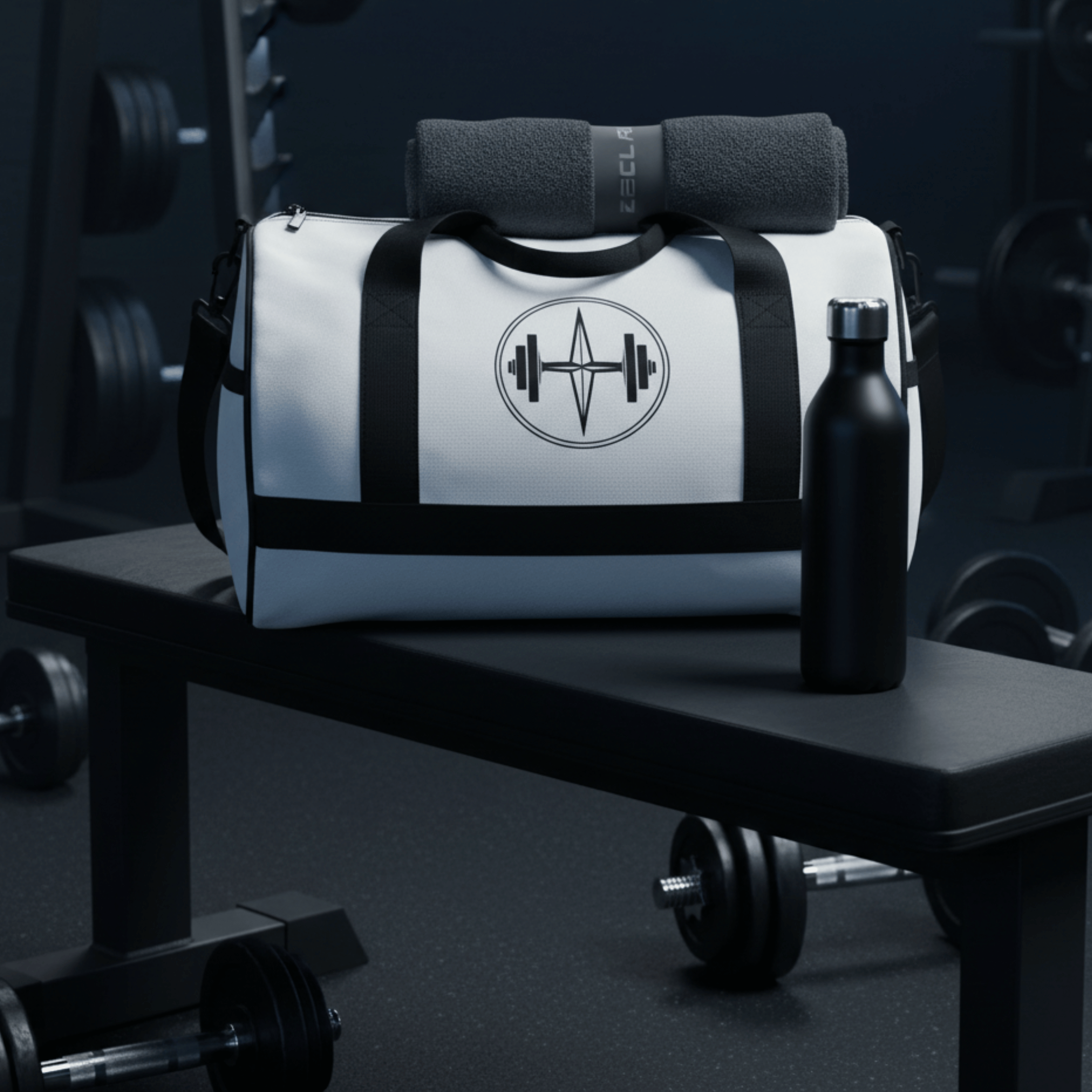 White gym bag with black accents and a logo on a gym bench with a water bottle and dumbbells.