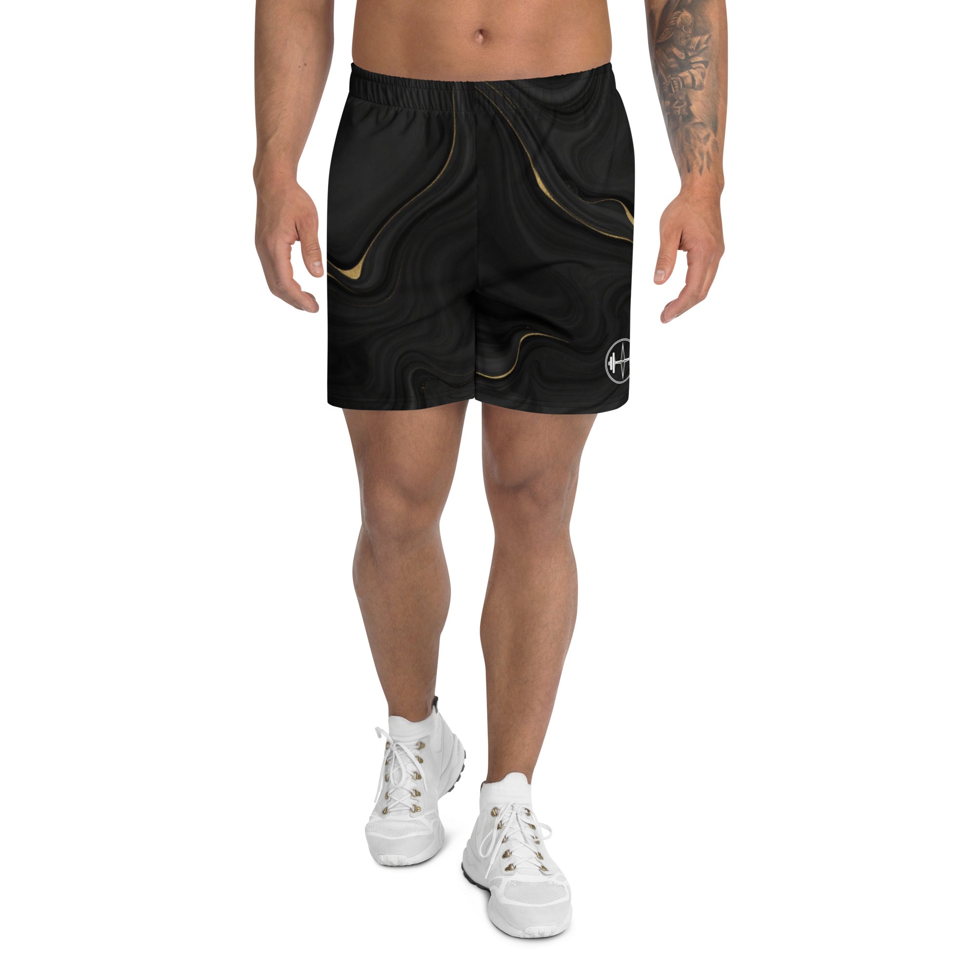 Person wearing black shorts with gold accents on a white background