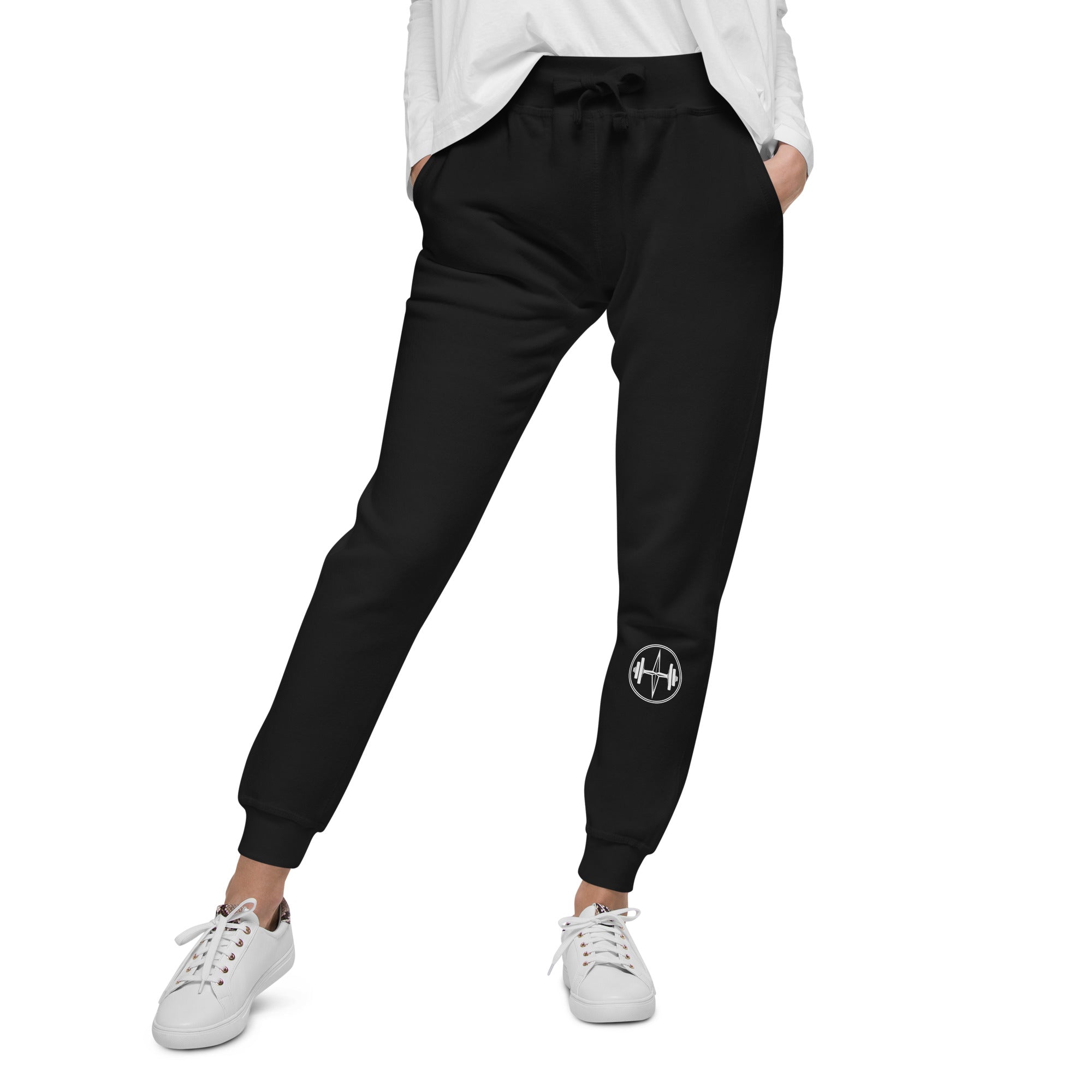 Person wearing dark gray sweatpants with a logo on a white background