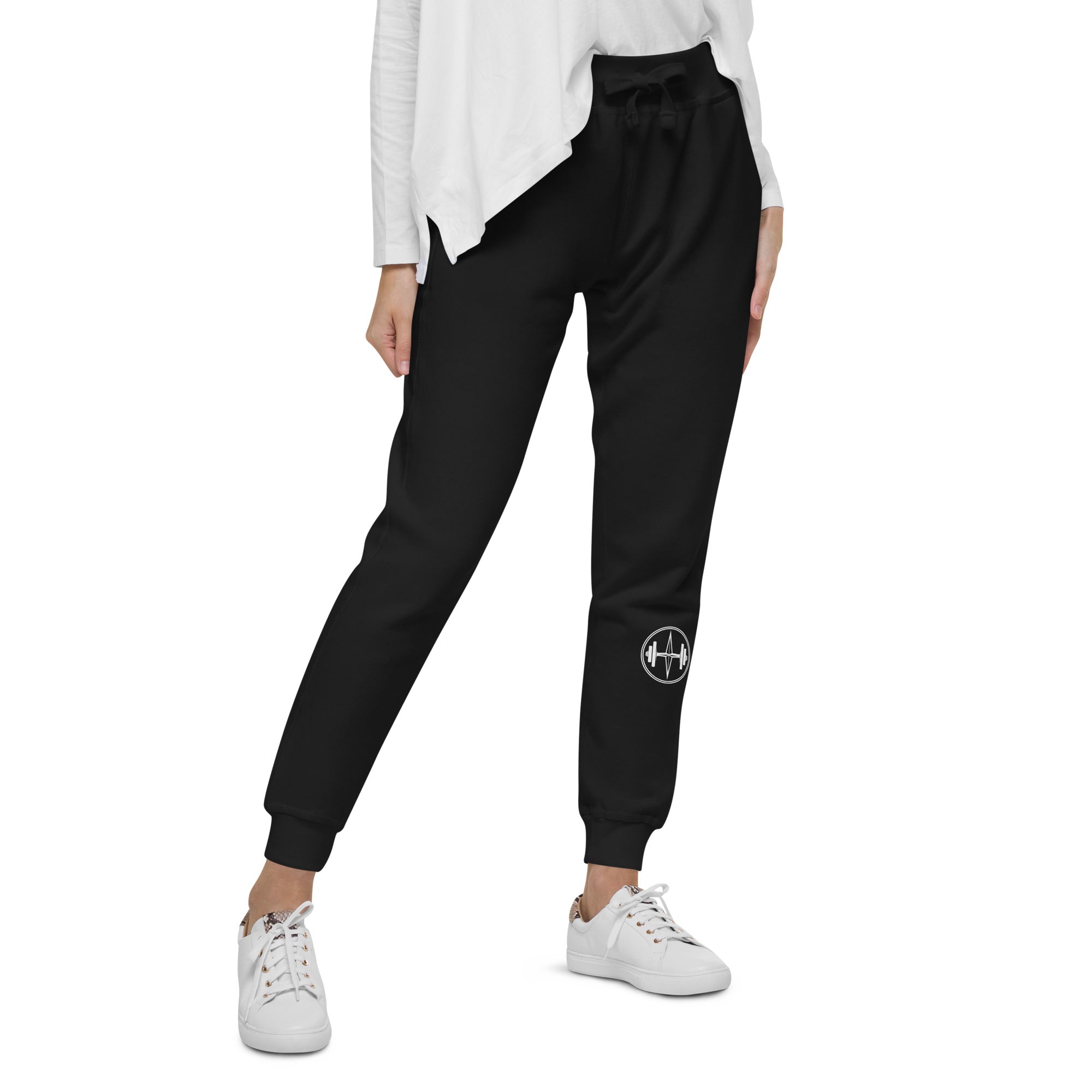 Black jogger pants with a pattern on the side worn by a person on a white background